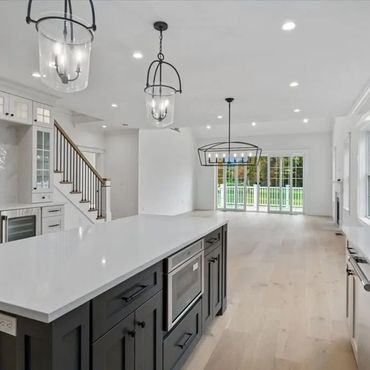 Modern kitchen with a large island and pendant lights.