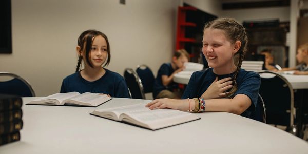 Telos Classical Christian School students reading Scripture