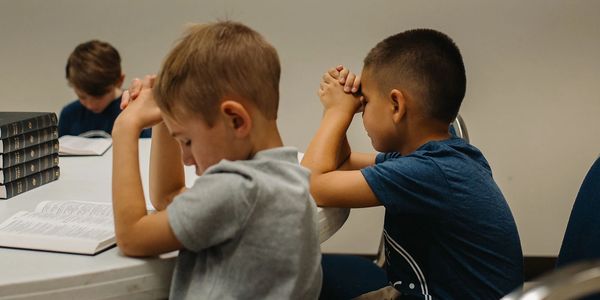 Telos Classical Christian School students praying