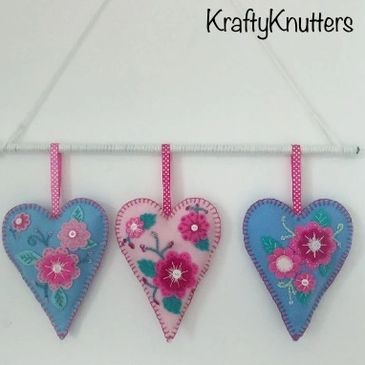 Three embroidered handmade felt hearts, baby blue, pale blue and baby pink
