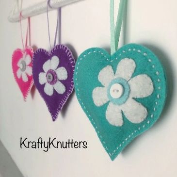 Three handmade felt heart with embroidered daisy