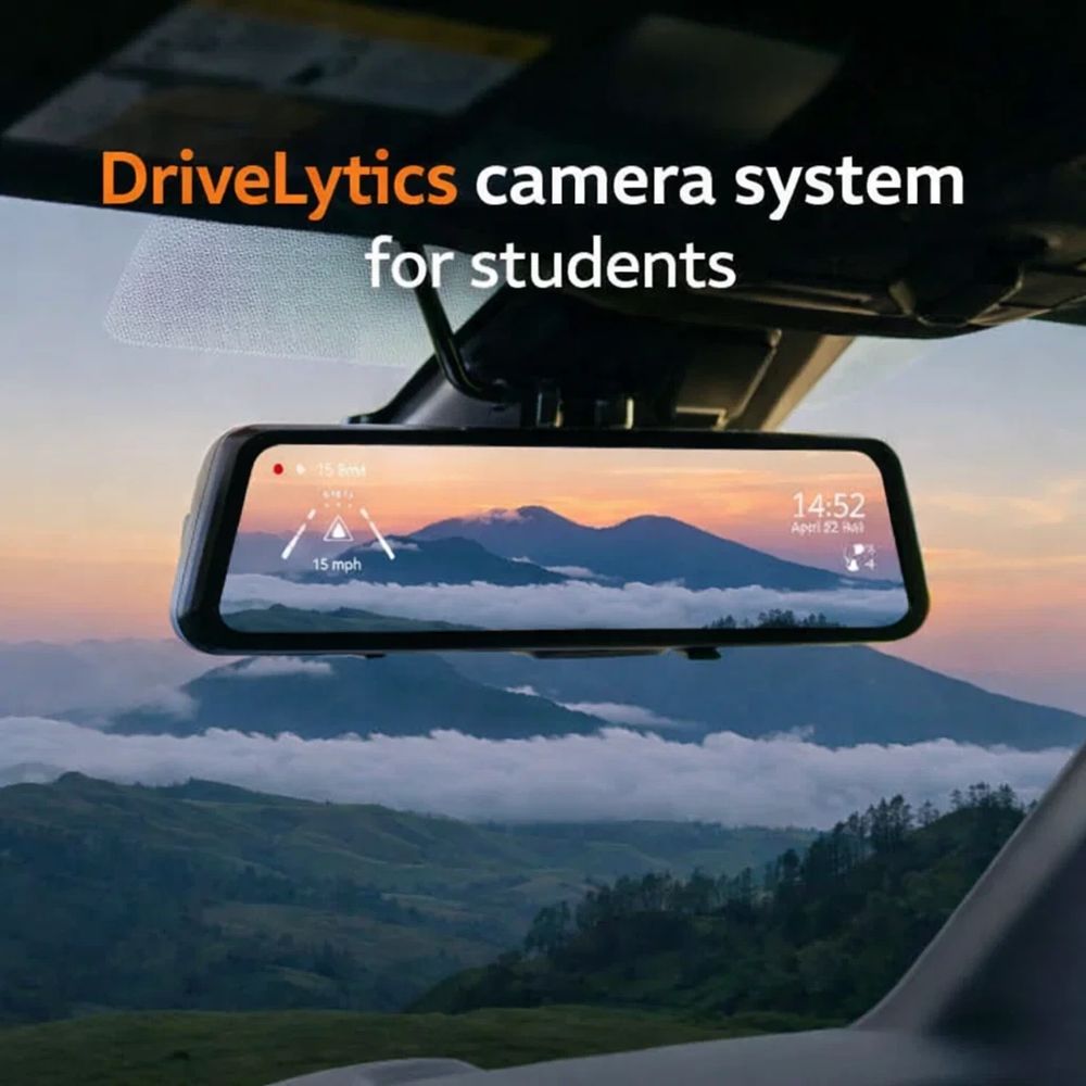 DriveLytics camera system displayed on a car rearview mirror with scenic mountain view.