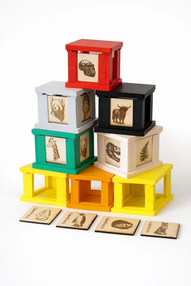 Stacked colorful wooden blocks with engraved animal and skull images.