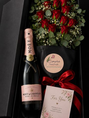 Elegant gift box with roses, champagne, and a heartfelt card.