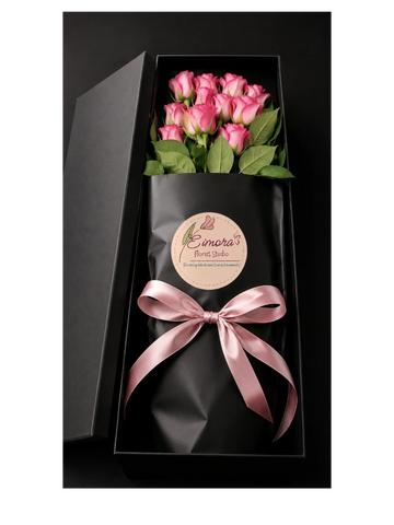 Elegant bouquet of pink roses in black gift box with satin ribbon.