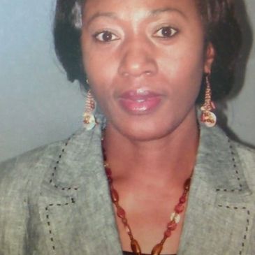 Portrait of a woman with earrings and a blazer.