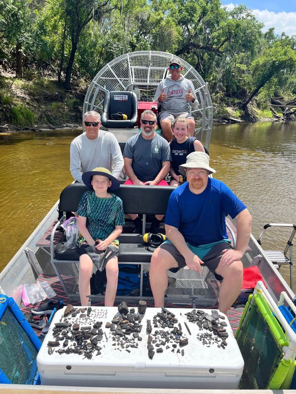 Fossil Junkies guests on a Peace River fossil hunting tour with Ice Age fossils and shark teeth.