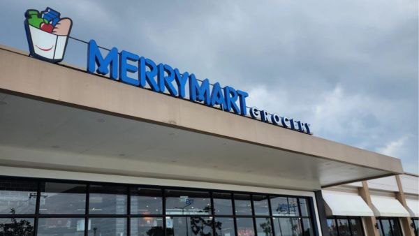 Exterior of Merrymart Grocery store under a cloudy sky.