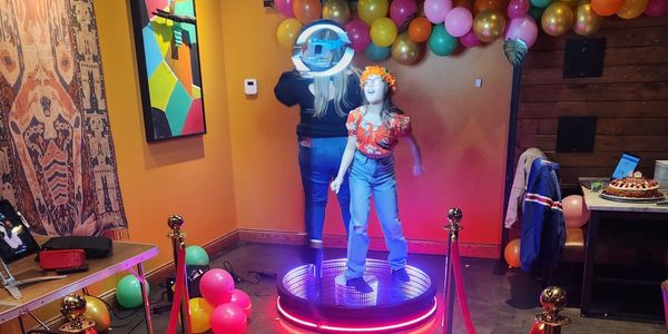 360 photobooth at birthday parties with red carpet and golden stanchions for rent.