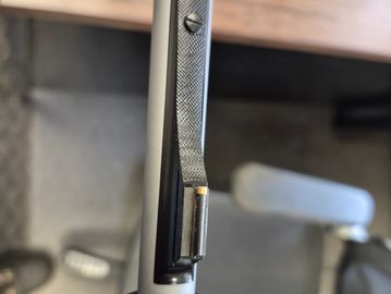 Close-up of a firearm's rear sight and barrel.