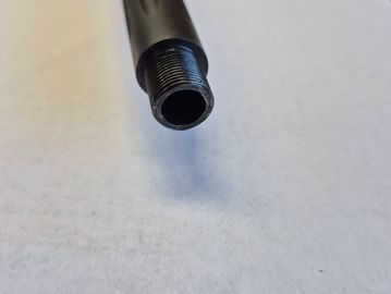 Close-up of a threaded black cylindrical metal pipe end.