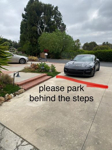 Driveway with parking instructions in front of steps.