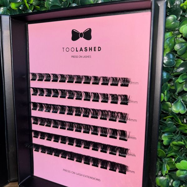 Box of TOOLASHED press-on eyelash extensions in various lengths.