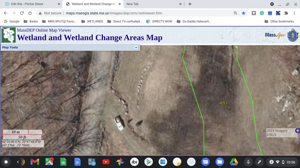 Aerial map view showing wetland boundaries and a vehicle near a tree line.