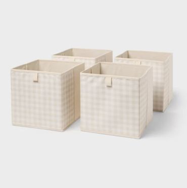 Set of four beige checkered fabric storage bins.