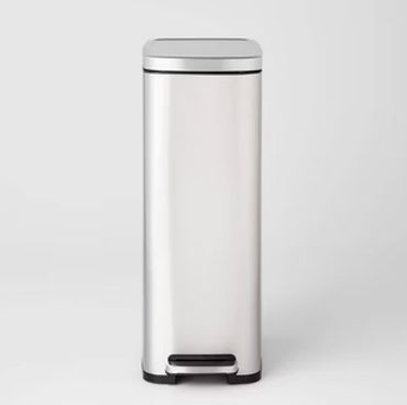 Tall silver trash bin with foot pedal.