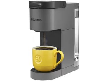 Keurig coffee maker brewing coffee into a yellow cup.
