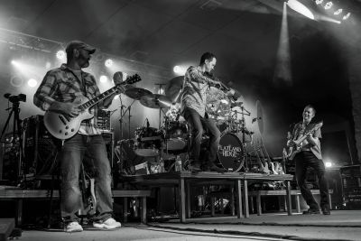 Black and white photo of a band performing on stage.