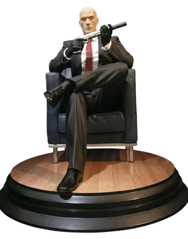 Figure of Hitman sitting on a chair holding a gun.