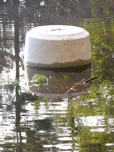 A white concrete pedestal partially submerged in a tranquil