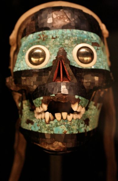 Ancient mosaic skull with turquoise and shell inlays and teeth.