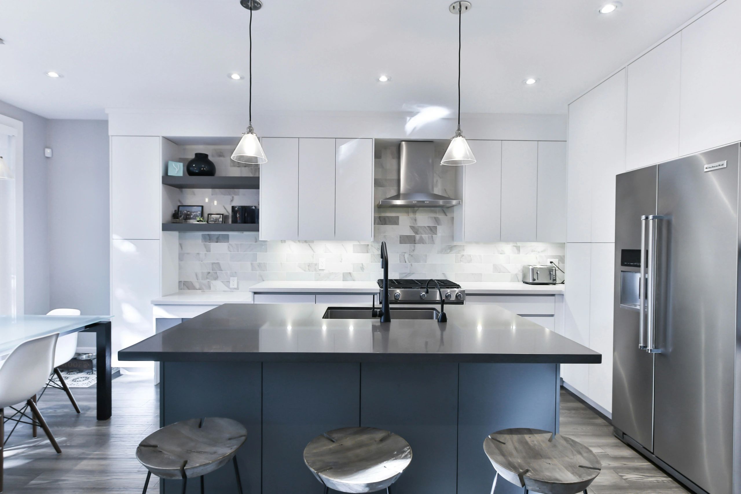White, blue, and gray themed kitchen that is super clean.