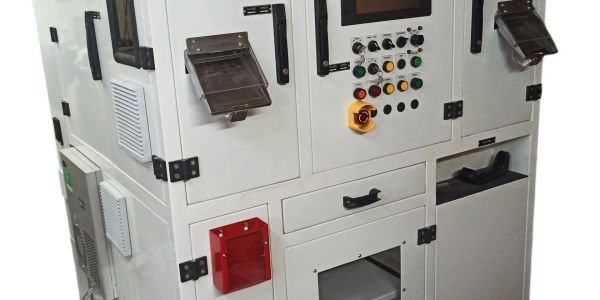 Industrial ID label laser marking machine with dual stations and control panel.