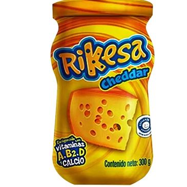 Rikesa Cheddar cheese spread in a yellow jar with nutritional highlights.