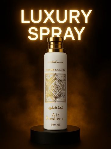 Elegant luxury spray air freshener with gold accents on a black pedestal.