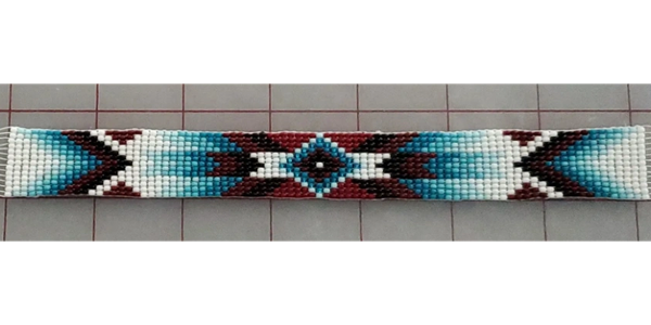Handwoven beaded belt inlay strip with a turquoise, white, and maroon geometric design.