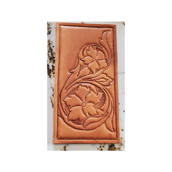 Leather trading card with western floral carving design.