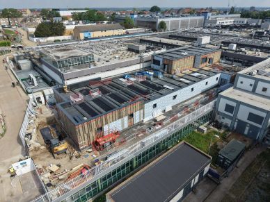Aerial view of a large industrial building under construction.
