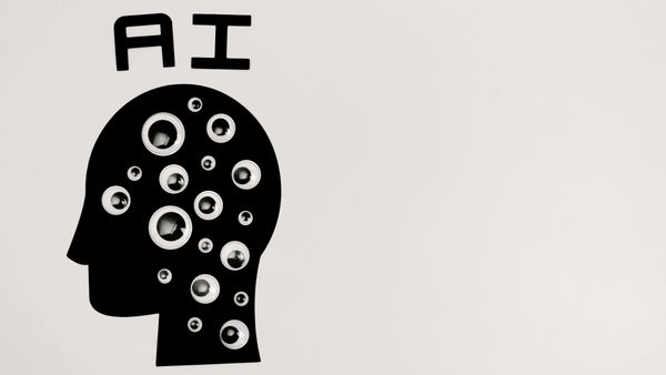 AI concept with googly eyes inside a head silhouette.