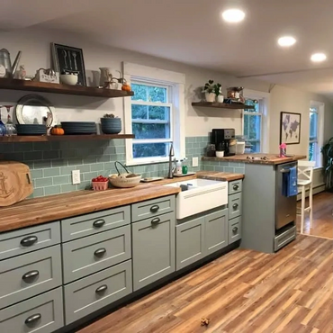 Glass subway tile and open shelving keep this kitchen bright and airy.