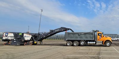 Construction machinery loading materials into a dump truck.