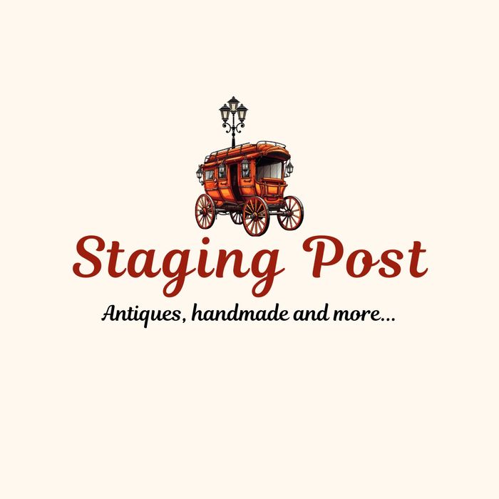 Stack of books next to pencils in a holder and a camera.