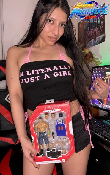 Young woman holding a John Cena action figure.