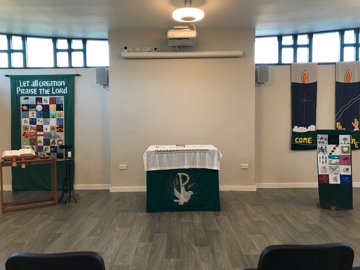 The Chapel with bible, lectern and table decorated with modern tapestries and decor. 