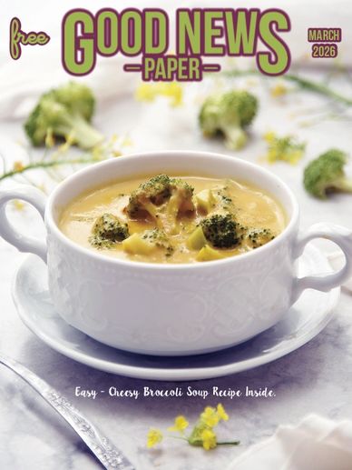 Creamy broccoli soup served in a white bowl on a plate.