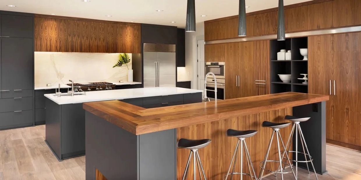 Modern kitchen with wood and dark cabinets and a large island.