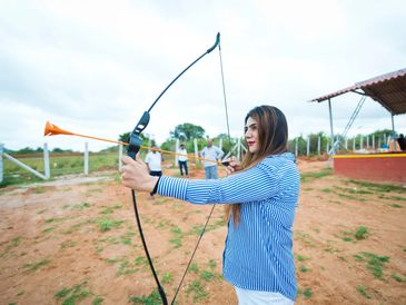 Focused guest taking aim during an archery session at Namooru Hillview Resort