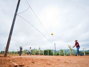 Energetic guests engaged in a spirited volleyball match at Namooru Hillview Resort