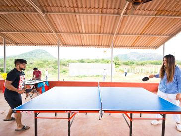 Guests immersed in a competitive table tennis game at Namooru Hillview Resort
