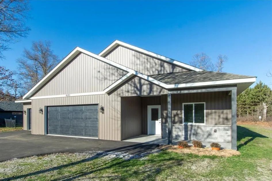 Modern single-story house with a two-car garage and a gray exterior.