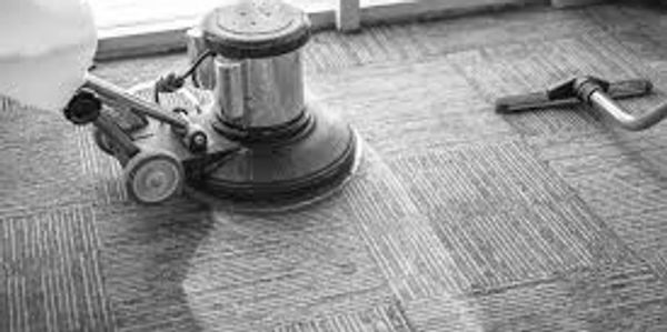 Floor cleaning machine polishing carpet tiles.