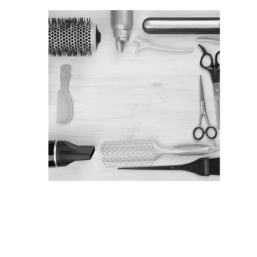 Hair styling tools and accessories arranged neatly on a wooden surface.