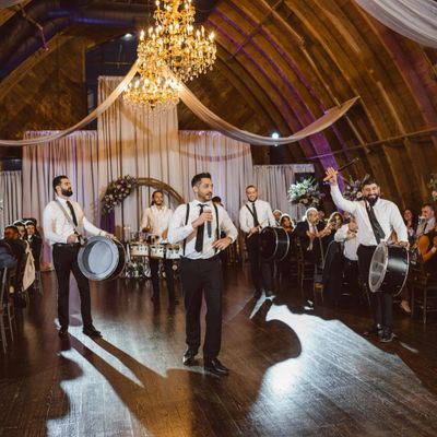 A lively drum performance at an elegant indoor wedding reception.