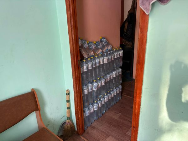 Stack of water bottles in a doorway.