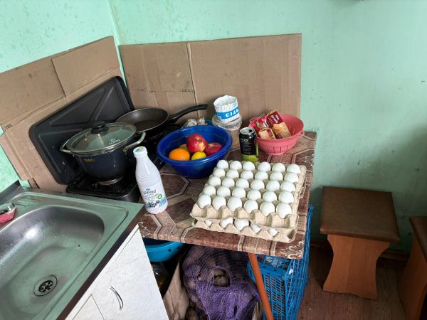 Kitchen corner with eggs, fruits, and cooking essentials.