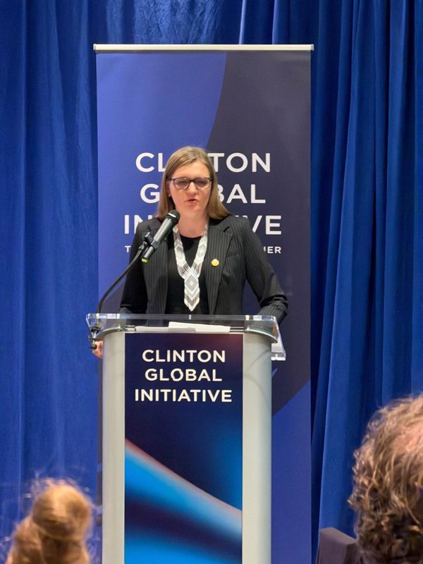 Woman speaking at Clinton Global Initiative event.